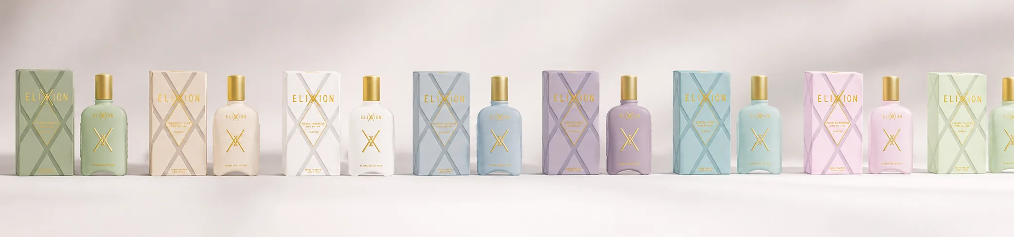 All eight ELIXXION Eaux de Toilette lined up beside their cartons